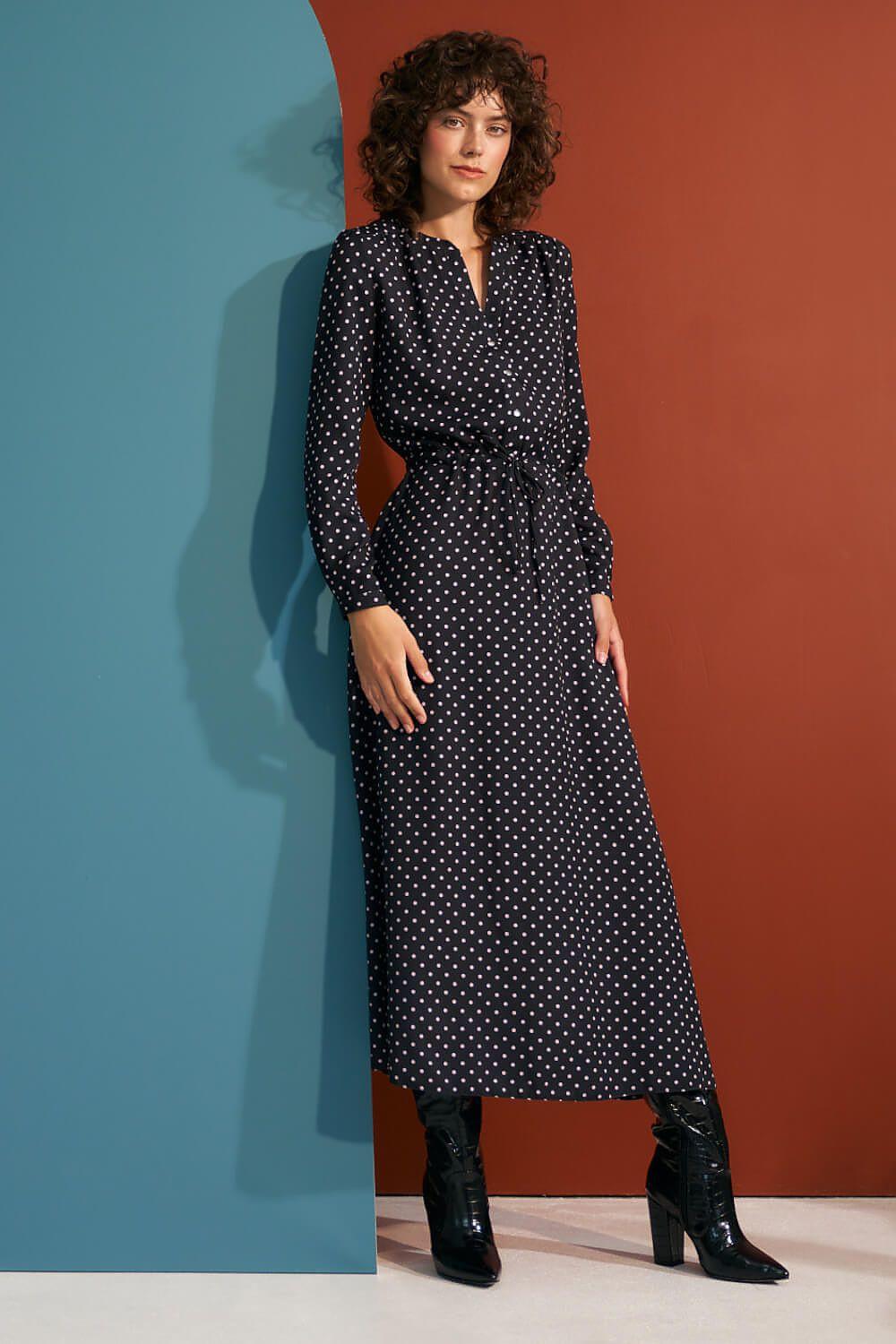 Black long-sleeve daydress with buttoned V-neck, waist tie, and white dot print