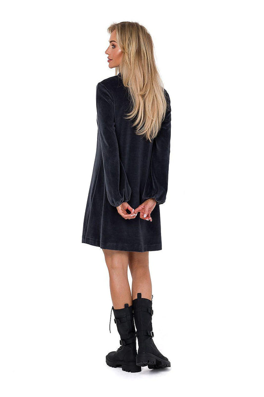 Black day dress with V-neck, long sleeves, and above-knee hem, side view