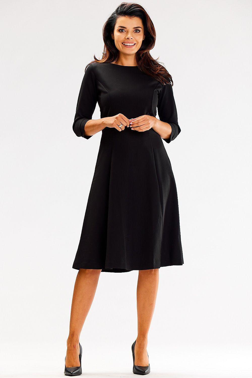 Black daydress with round neckline, 3/4 sleeves, A-line midi length.