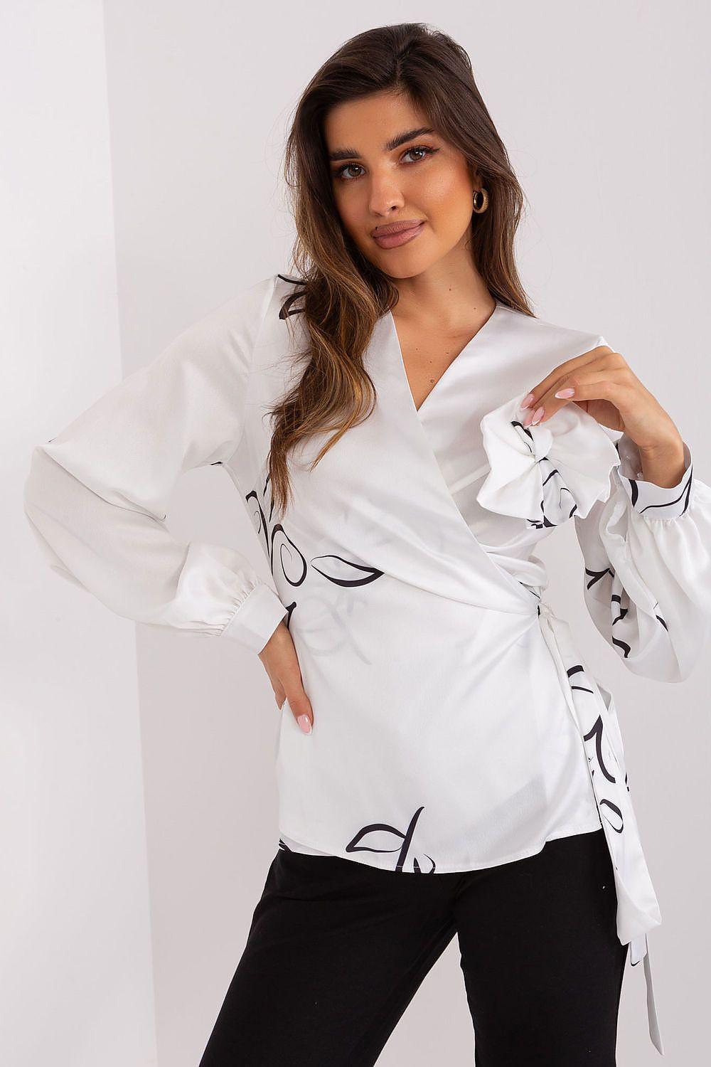 White blouse with envelope front and heart neckline, long sleeves and ruffled cuffs
