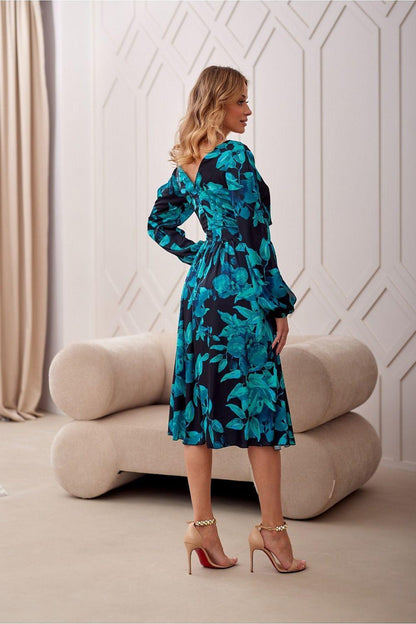 Teal and black leaf-print cocktail dress, V-neck, long sleeves, midi length, side view