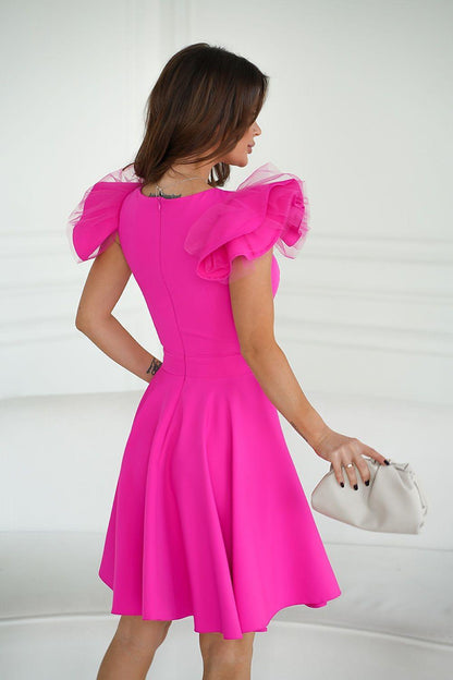 Pink cocktail dress, back view, with ruffled shoulder detail and flared pleated skirt