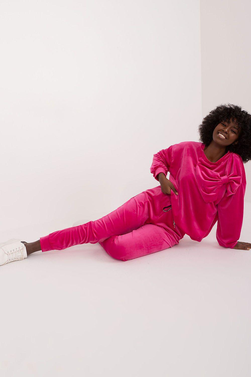 Pink velour loungewear set with draped long-sleeve top and matching pants