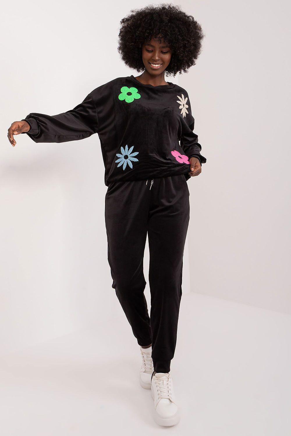 Black velour loungewear set with floral print sweatshirt and jogger pants