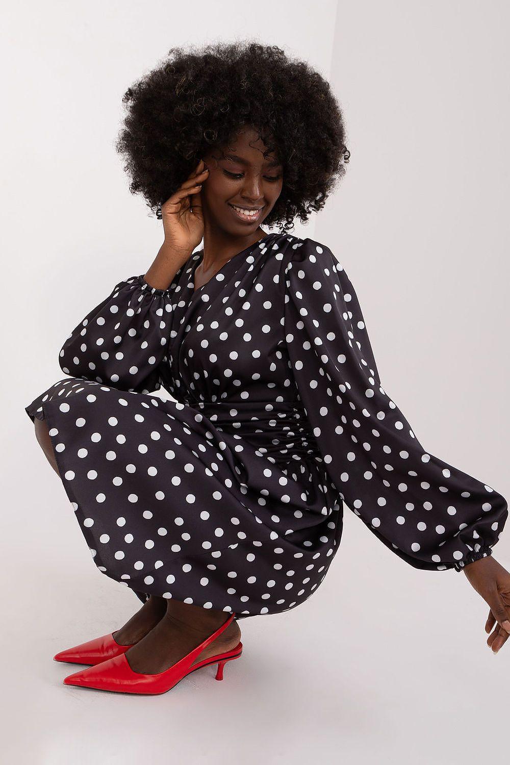 Black polka dot cocktail dress with long puff sleeves and gathered waist, flared skirt