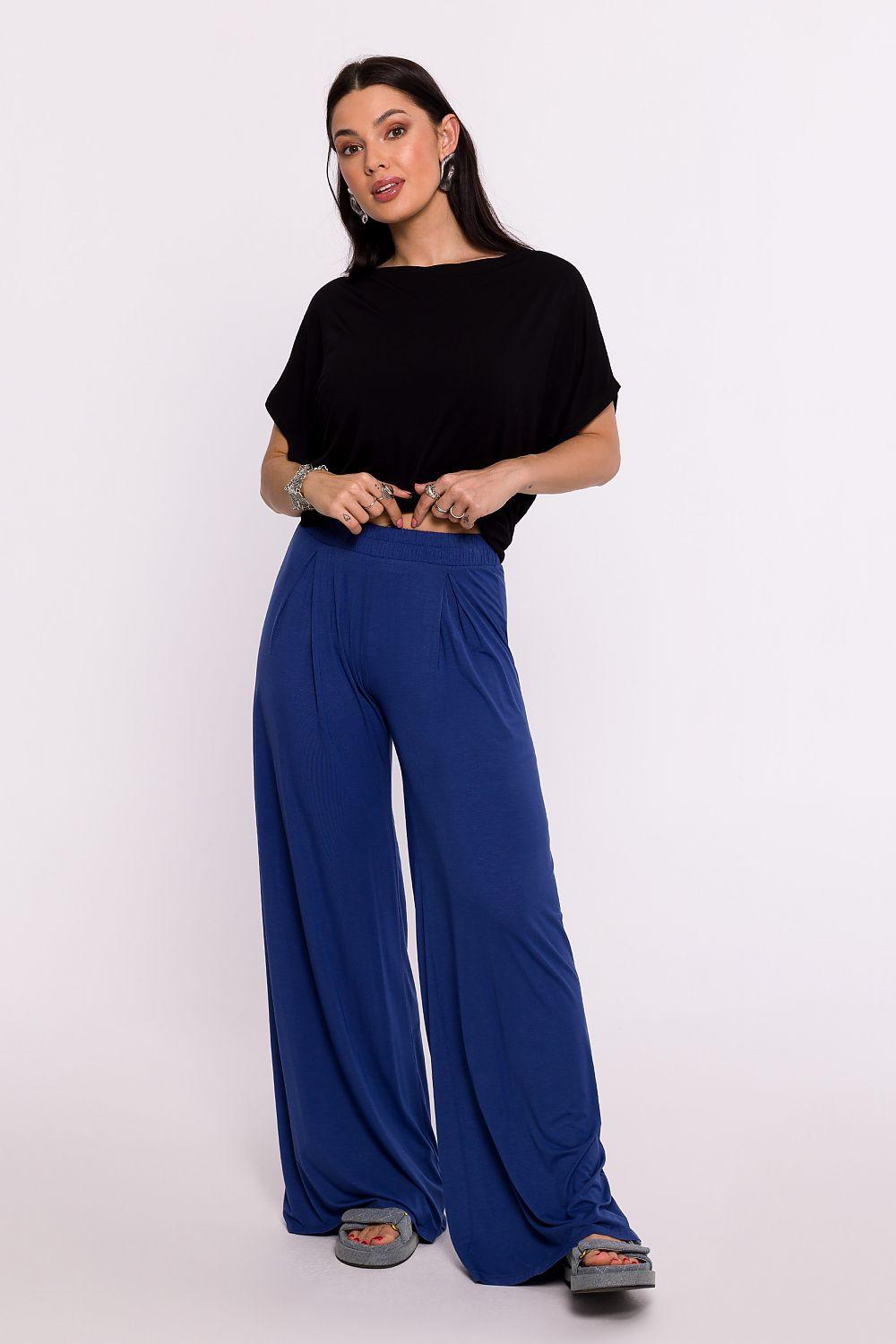 Blue wide-leg women’s trousers with relaxed waist and full-length drape.