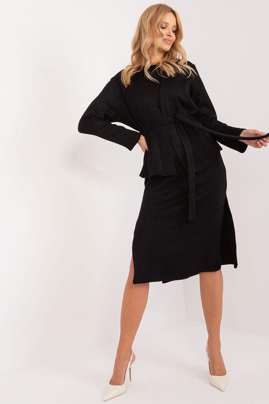 Black long-sleeve wrap blouse and belted skirt, knee-length hem, side pose