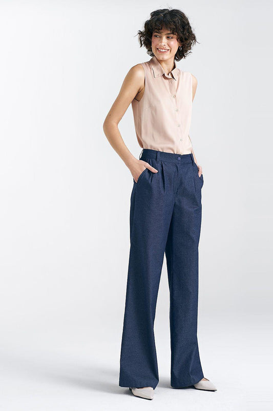 Beige sleeveless button-up shirt with pointed collar and front buttons.