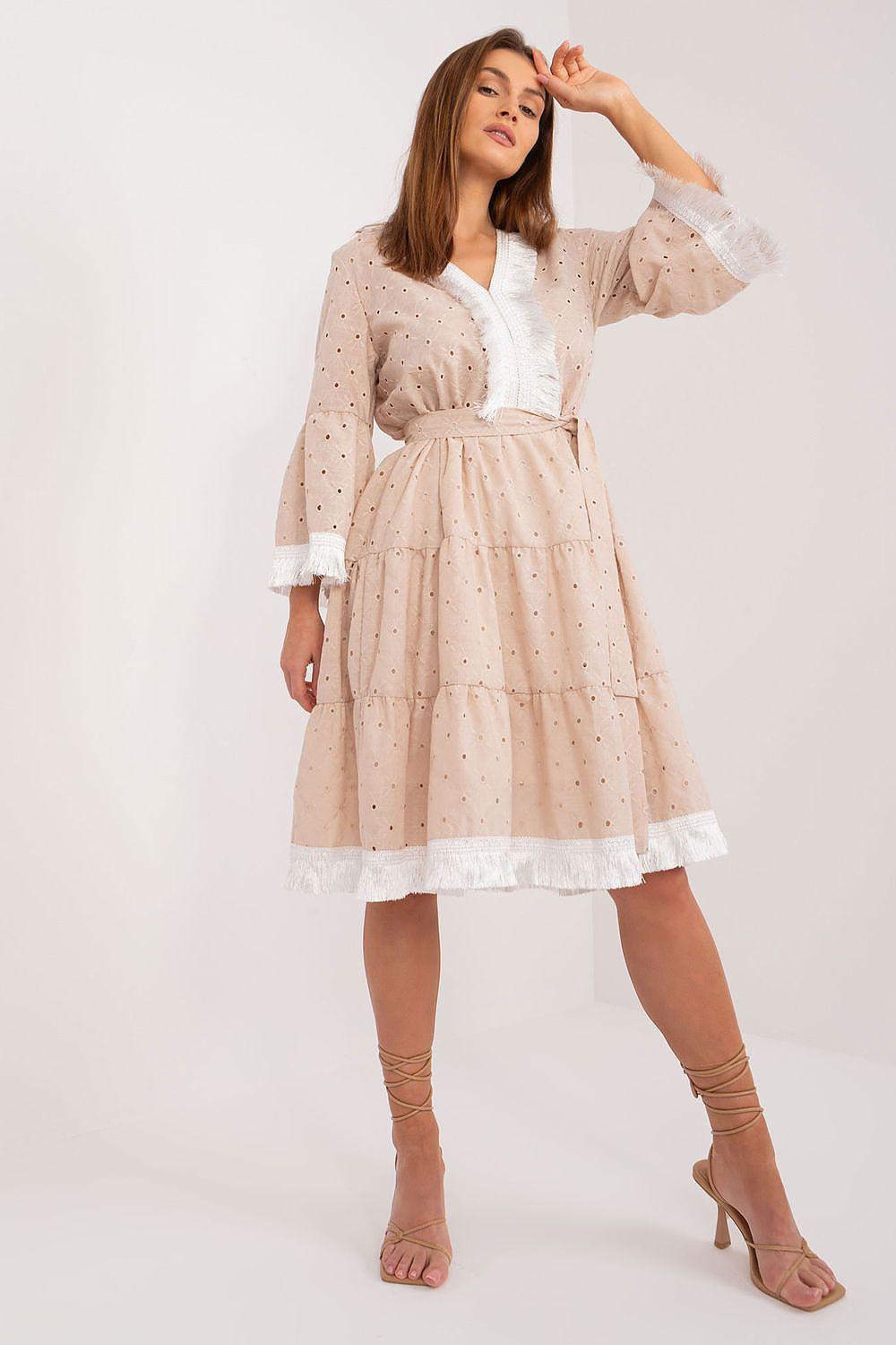 Beige daydress with V-neck, puff sleeves, waist tie belt, tiered skirt and lace trim