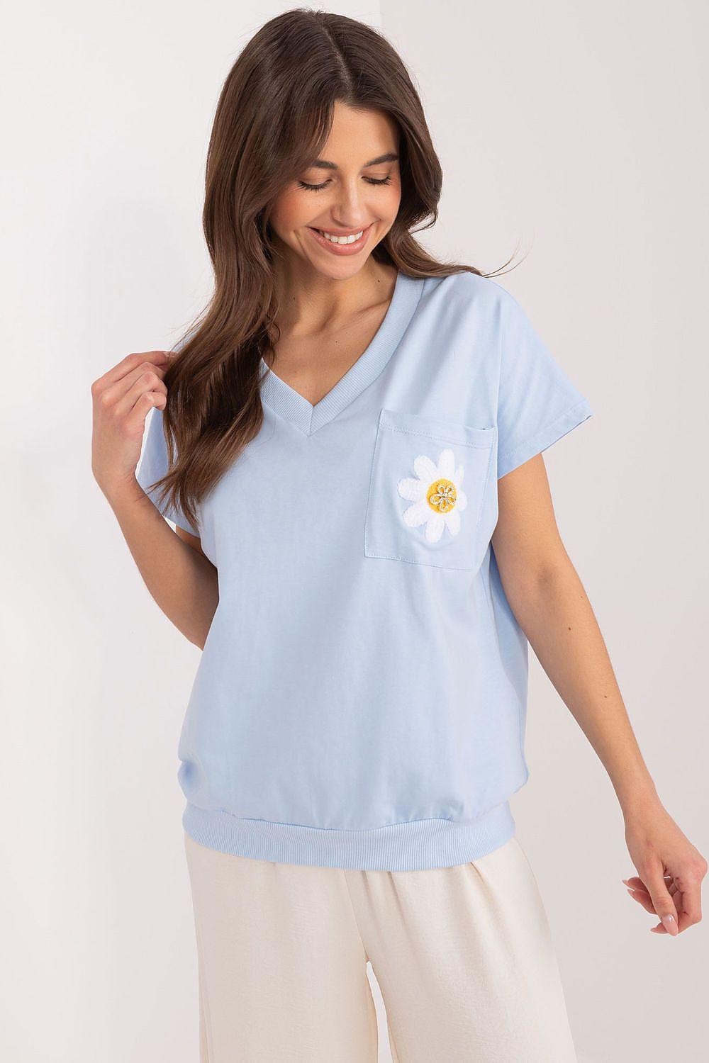 Light blue short-sleeve blouse with V-neck, front pocket, and daisy patch on chest