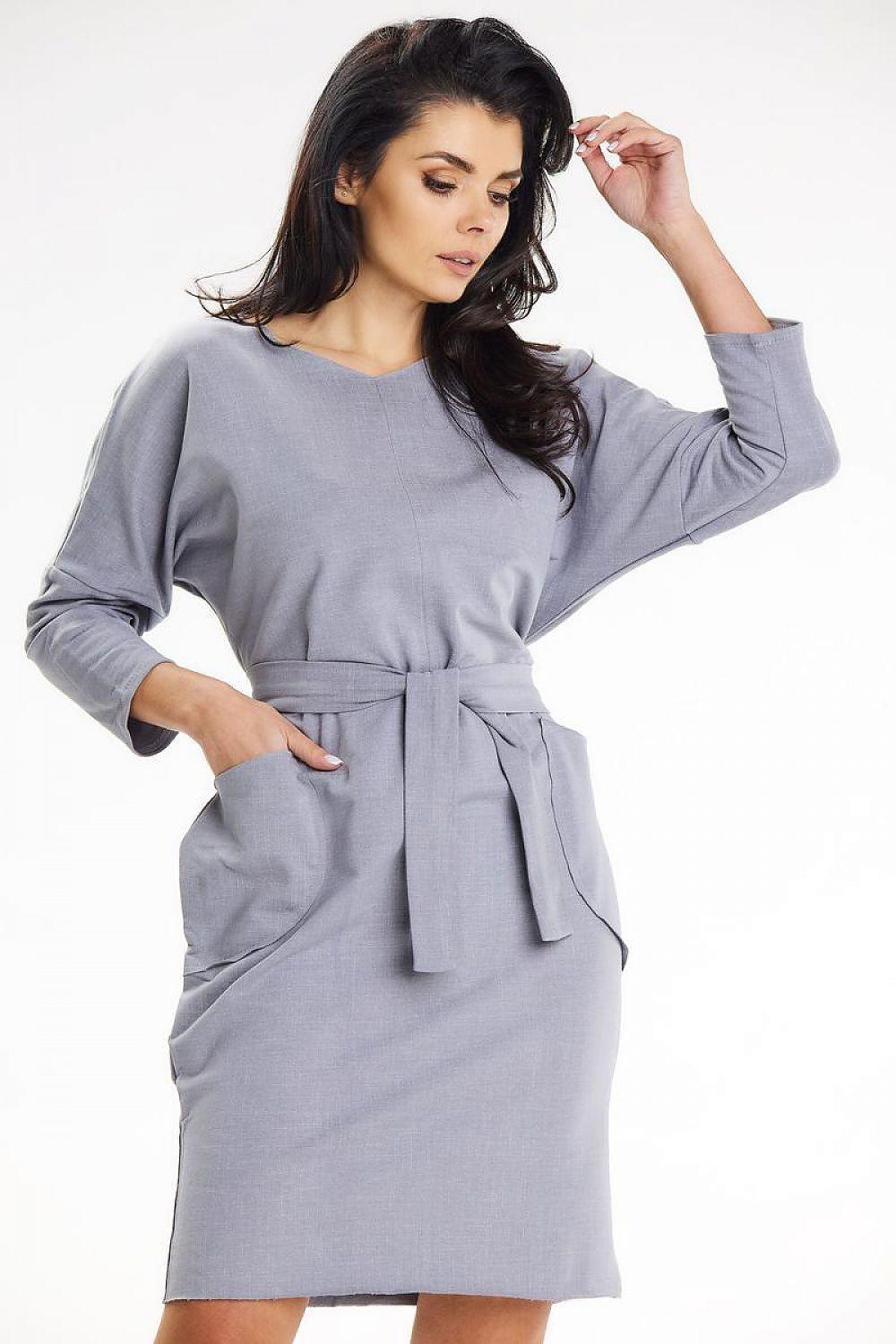 Grey daydress with long sleeves, round neck, and tie belt at waist