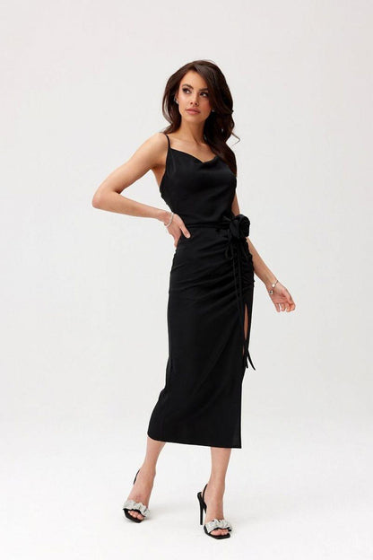 Black midi cocktail dress with ruched waist and side slit, tied detail at hip