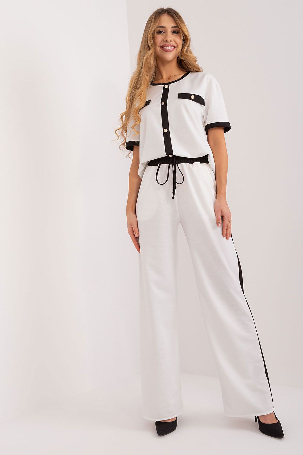 White blouse with black-trim collar, short sleeves, button front and tie waist.