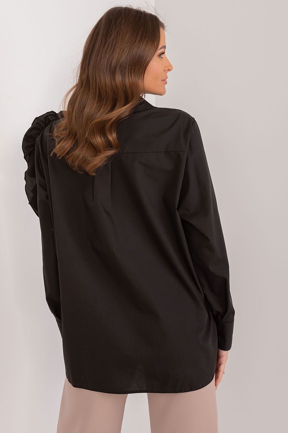 Black long-sleeve shirt back view with layered ruffle shoulder accent