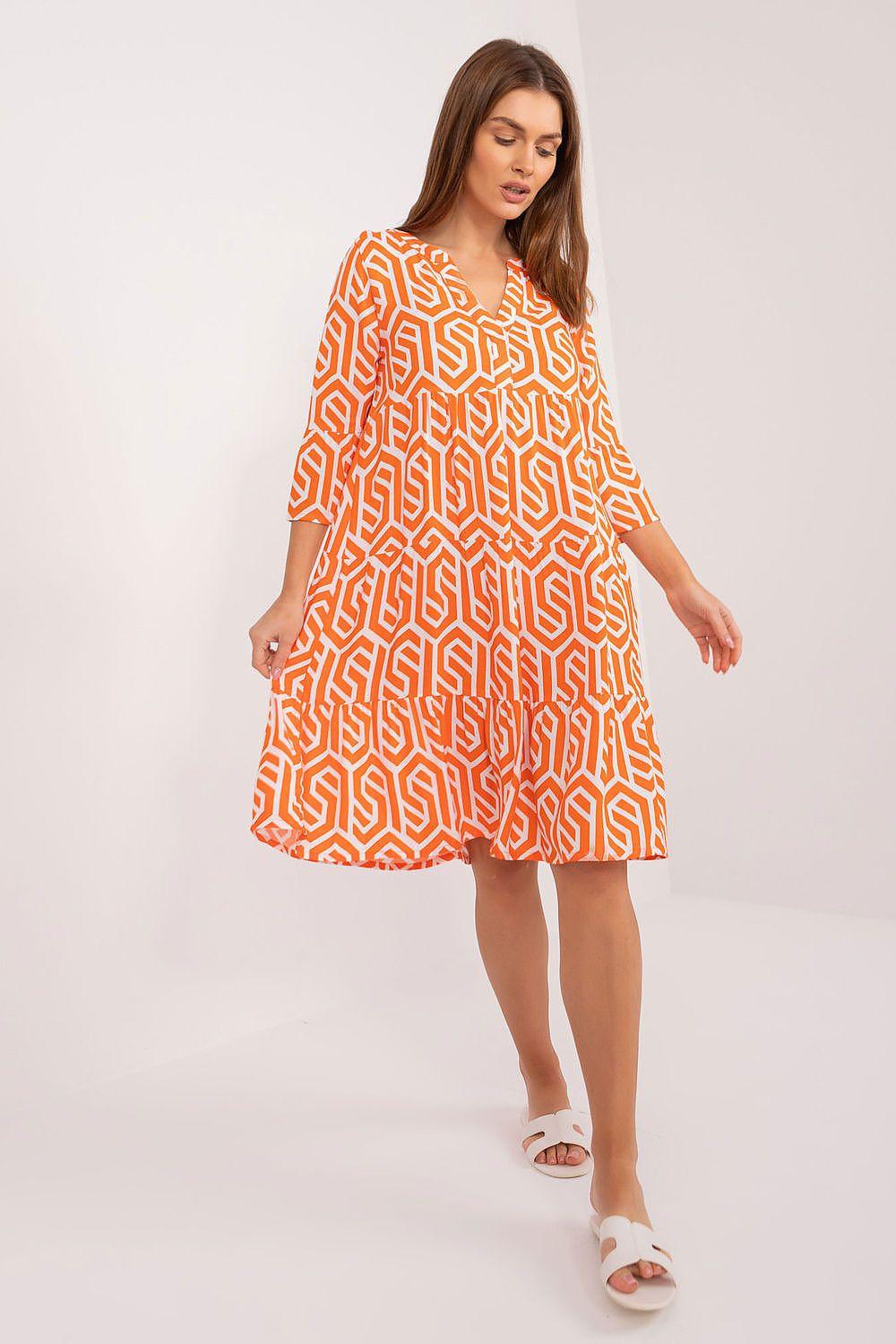 Orange patterned day dress with long sleeves and knee-length flared skirt