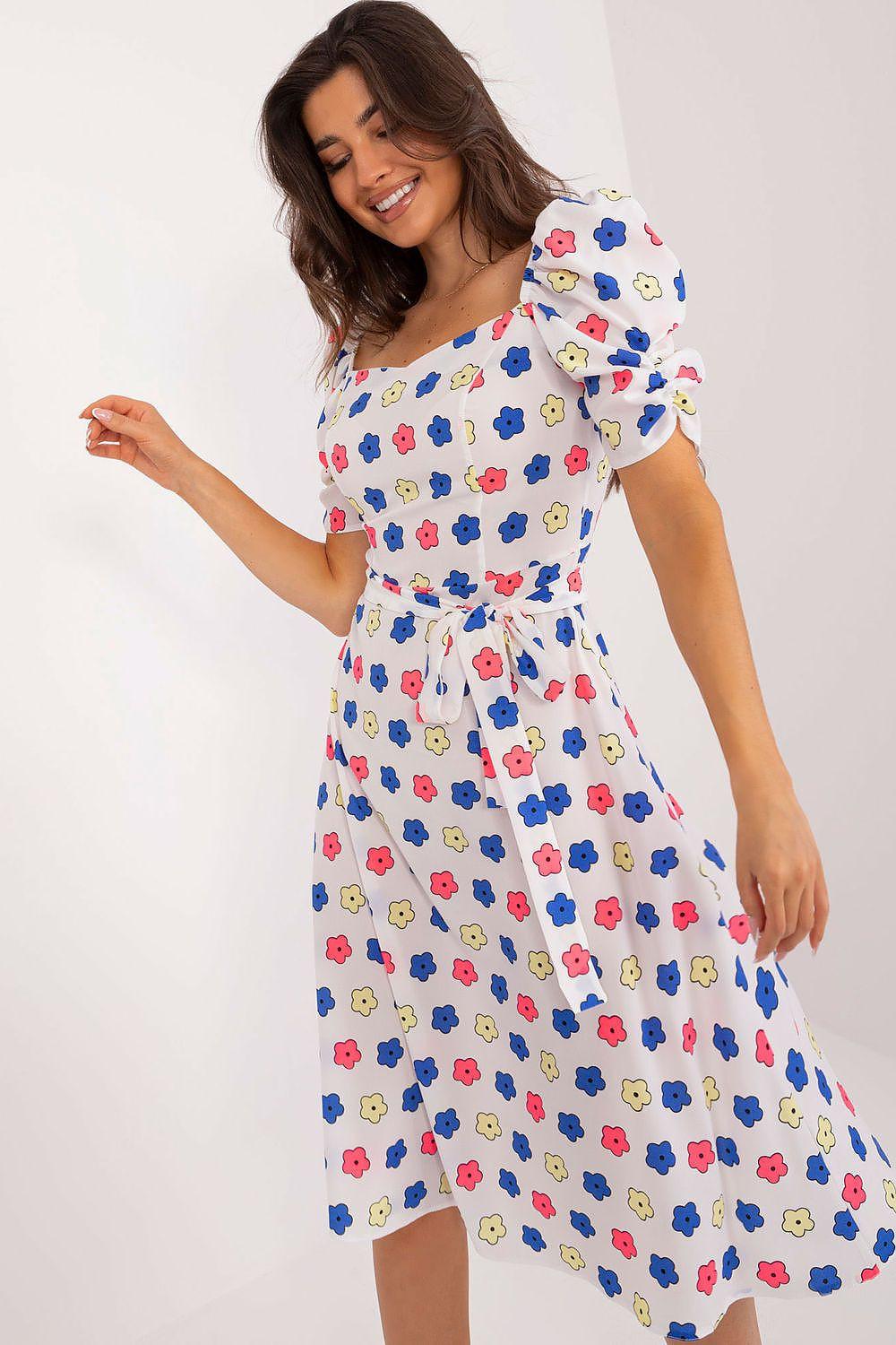 White daydress with colorful flower print, puff sleeves, and belted waist