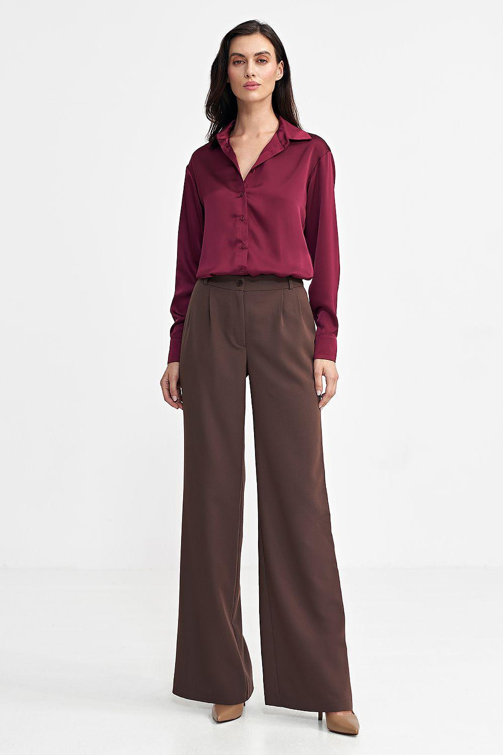 Dark brown wide-leg trousers with front button and relaxed waistband, full length.