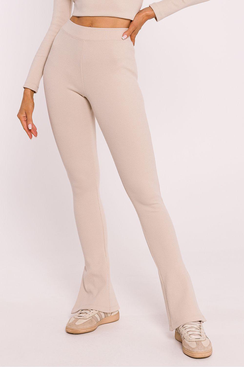 Beige flared cotton leggings with ribbed texture and side slits at hem