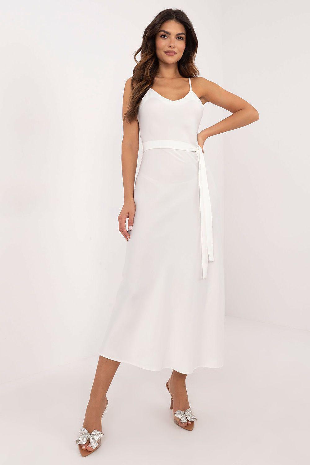 White evening dress with spaghetti straps, fitted waist, and side tie at the hip