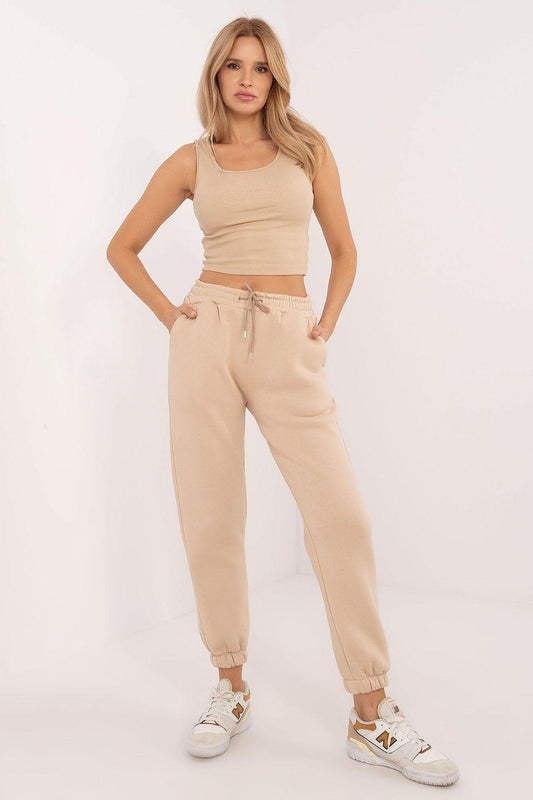 Beige sleeveless crop top and jogger pants set with drawstring waist