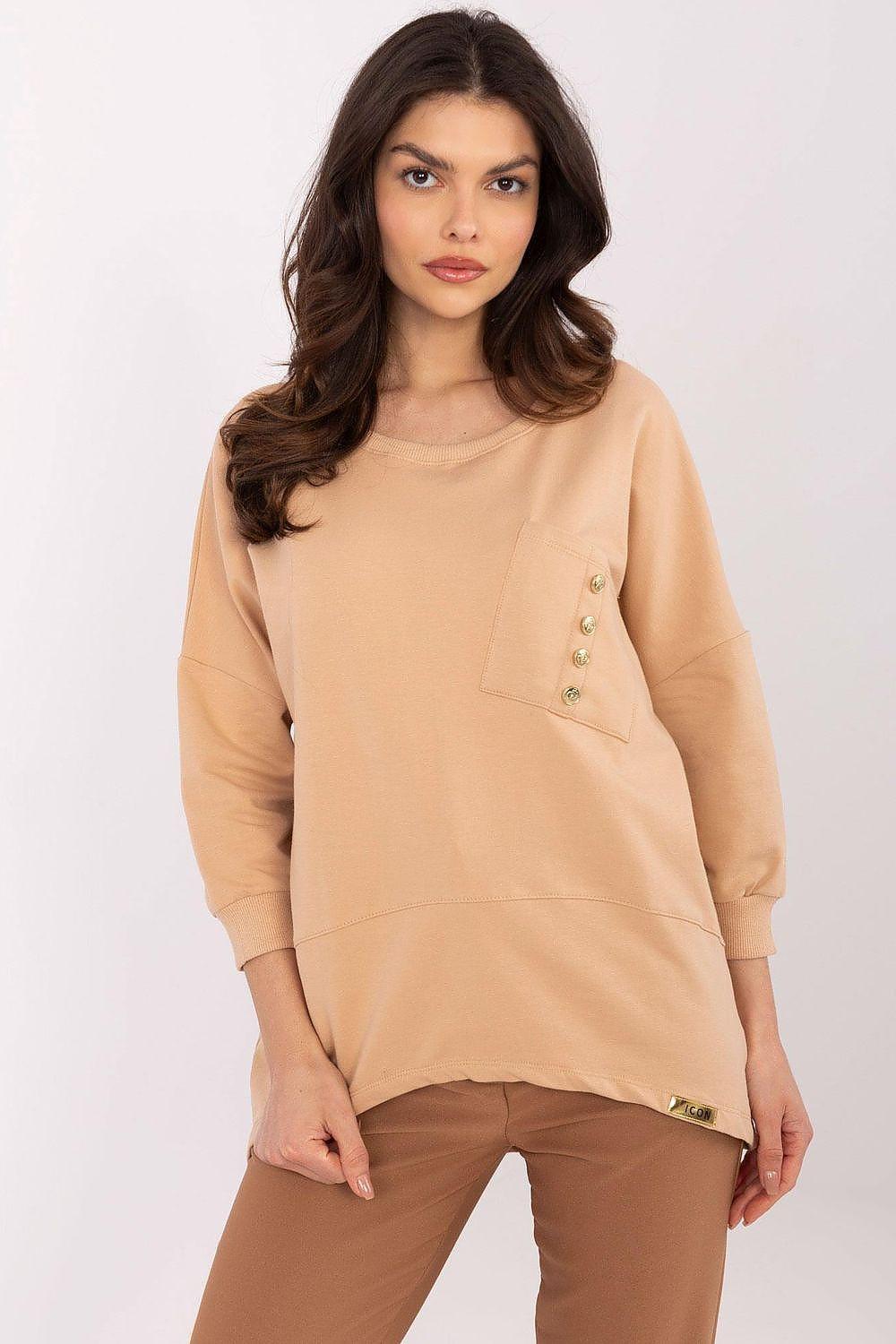 Tan blouse with long sleeves, round neck, and button pocket