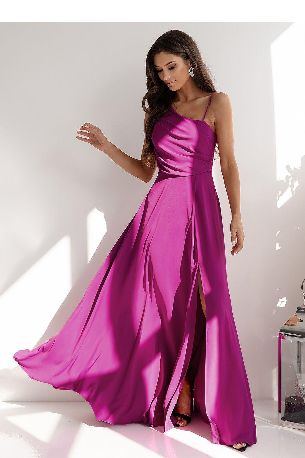 Fuchsia long dress with spaghetti straps, fitted waist, and flowing skirt with side slit.