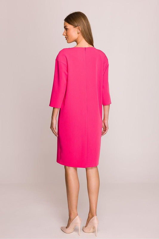 Pink day dress shown from the back, elbow sleeves and straight knee-length hem