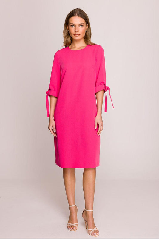 Pink daydress with 3/4 sleeves and side-tie ribbon accents, knee length
