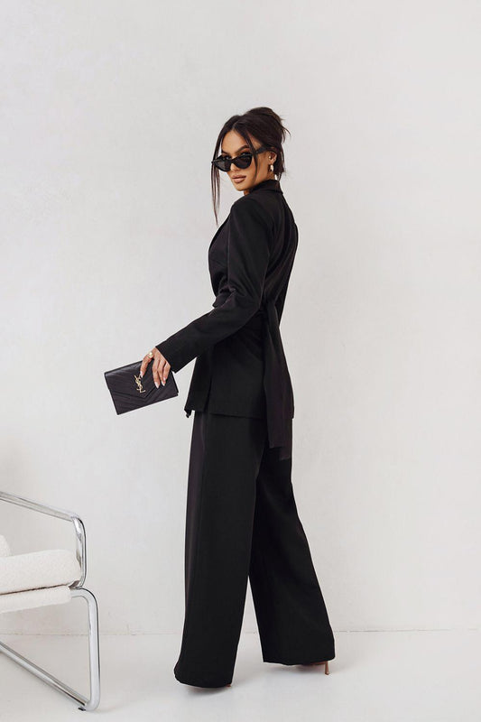 Black blazer and wide-leg pants set, side profile with long sleeves