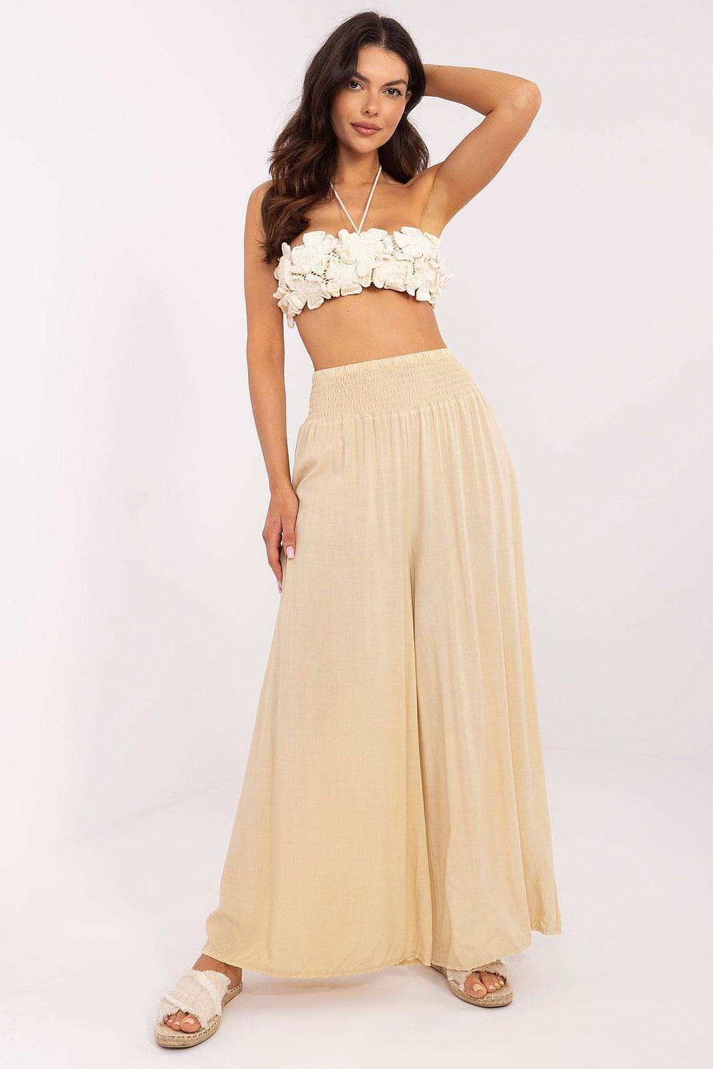 Beige wide-leg women’s trousers with elastic waist, flowing ankle-length