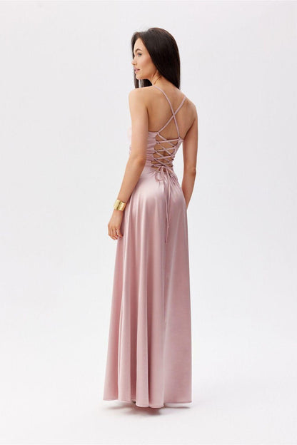 Pink backless long evening dress with crisscross open-back straps and side slit.