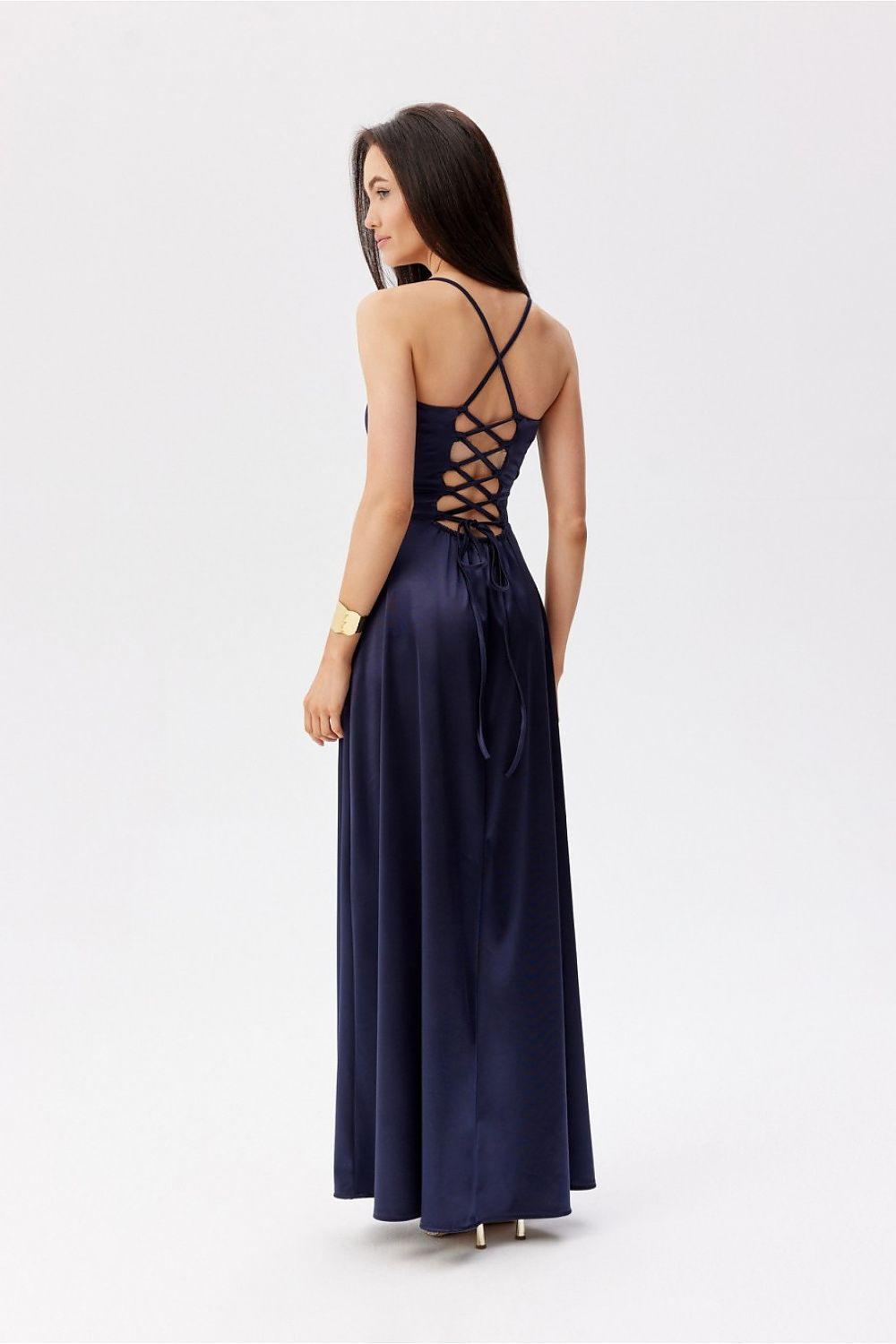 Navy backless long dress with crisscross open-back straps and lace-up detail.
