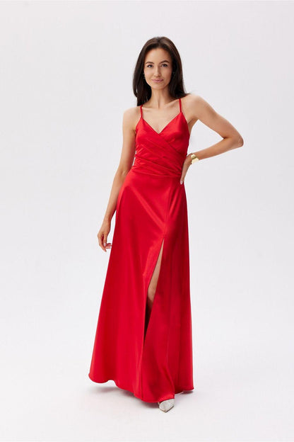 Red long evening dress with spaghetti straps, ruched bodice, and side slit.