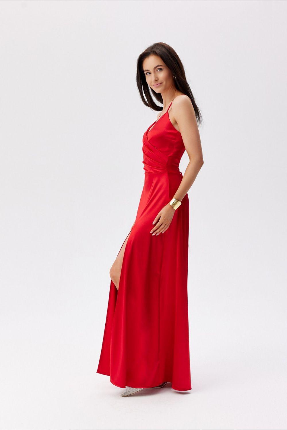 Red floor-length dress with spaghetti straps, ruched waist, and side slit.