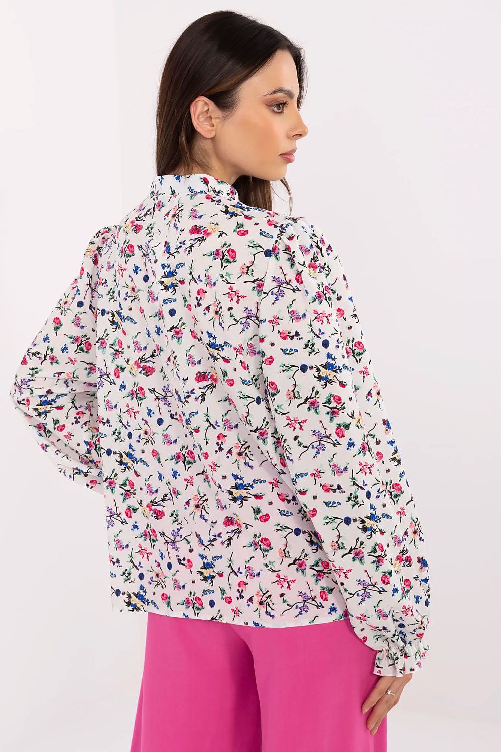 White floral long-sleeve shirt with puff sleeves and button detail at back