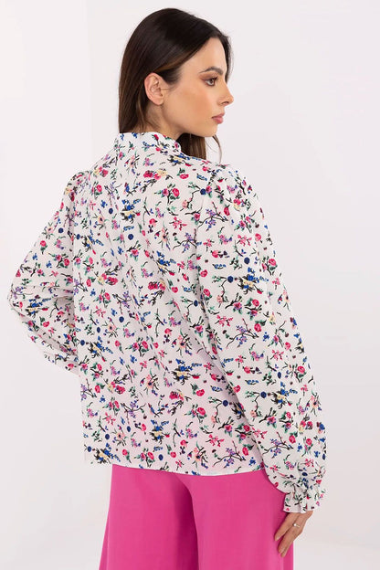 White floral long-sleeve shirt with puff sleeves and button detail at back