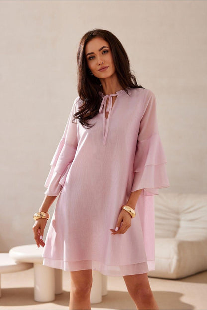 Pink cocktail dress with tied neck ribbon and tiered flounce sleeves