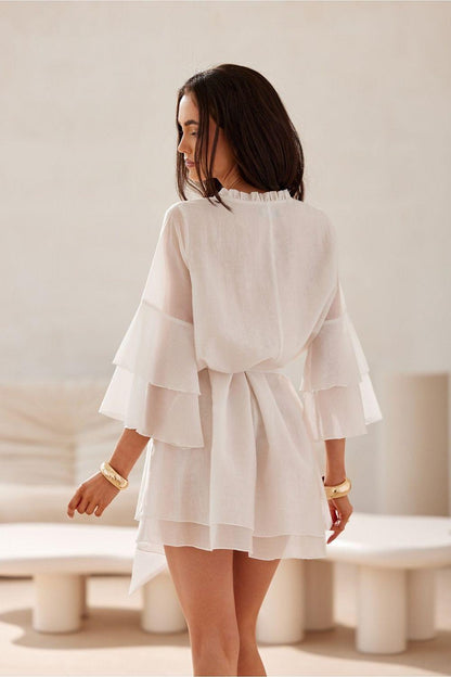 White cocktail dress with tied waist and tiered flounce sleeves, back view