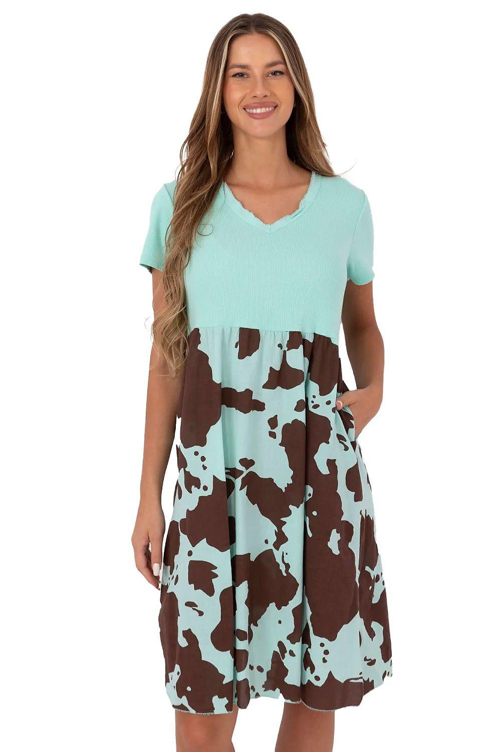 Green day dress with V-neck, short sleeves, and brown-and-white cow print skirt