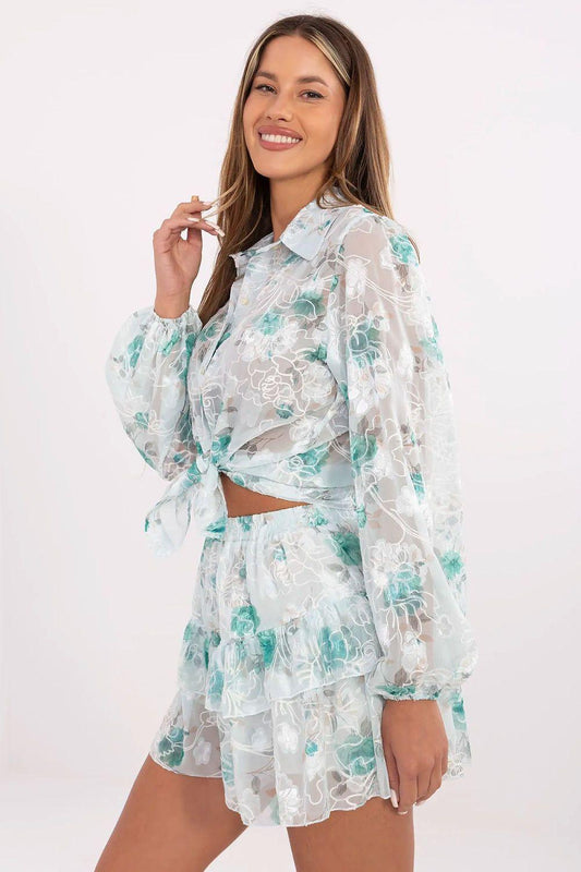 Green lace two-piece set: tie-front blouse with long sleeves and tiered mini skirt