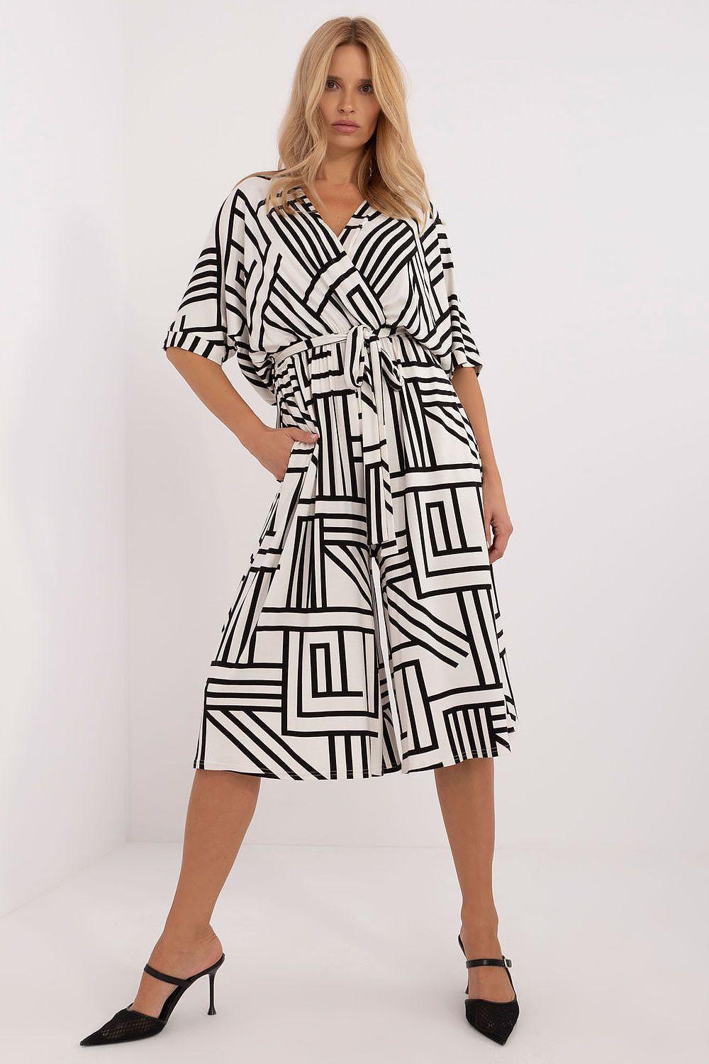 Black and white geometric print midi dress with belted waist and short sleeves