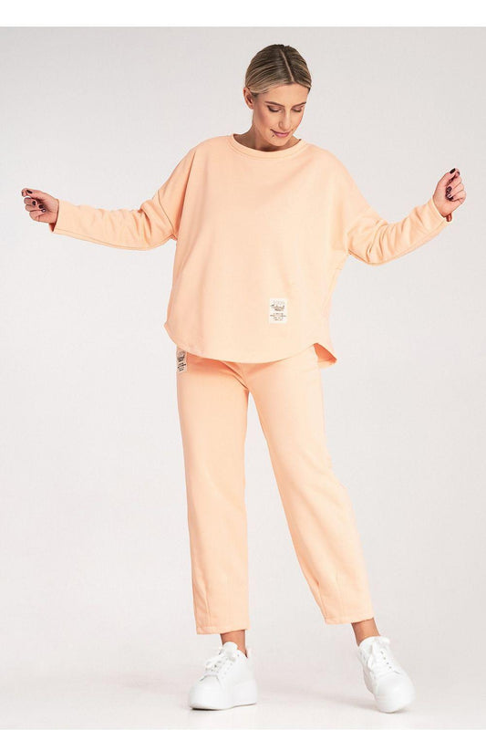 Two-piece loungewear set in light orange with long-sleeve sweatshirt and straight pants