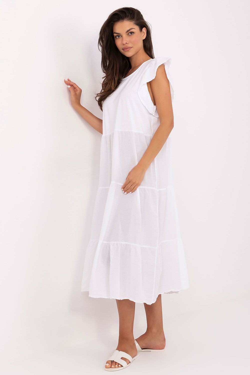 White cotton midi daydress with tiered skirt and frill cap sleeves, slight pose