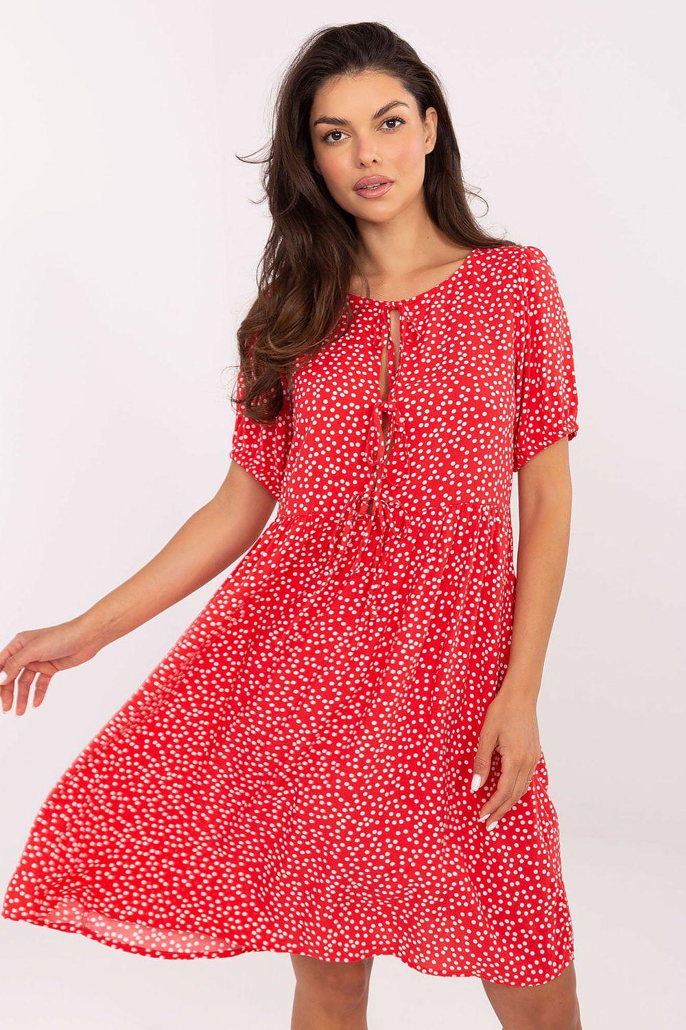 Red polka dot daydress with gathered keyhole neckline, short sleeves, and flared skirt