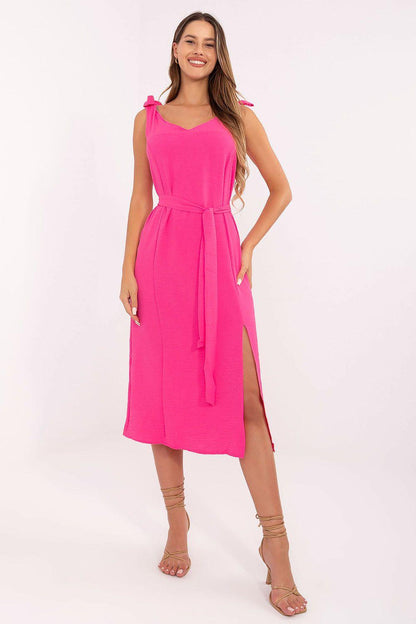Pink sleeveless daydress with V neckline, tie waist, and side slit