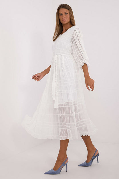 White midi daydress, tiered ruffle layers and flowy skirt with long puff sleeves
