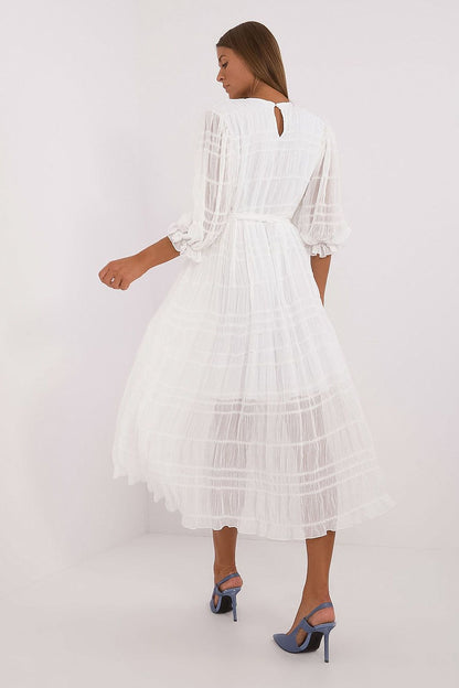 White midi daydress viewed from back, tiered flared skirt and long sheer sleeves