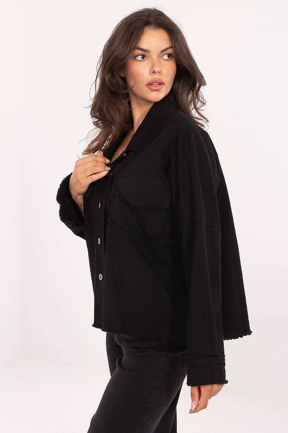 Black long sleeve shirt with button front and chest pockets, side view