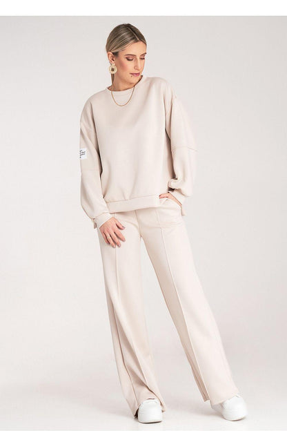 Beige two-piece loungewear set, side view, long sleeves and relaxed wide-leg trousers