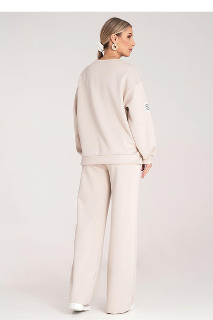 Beige two-piece loungewear set from the back with long sleeves and wide-leg pants